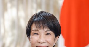 Takaichi Wins Second Term as Japan’s Prime Minister Sanae Takaichi stands at the parliamentary podium smiling while lawmakers applaud her re-appointment as Japan's first female Prime Minister.